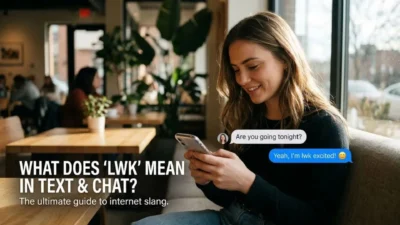 Young woman smiling while reading a text message using the slang lwk in a bright coffee shop setting